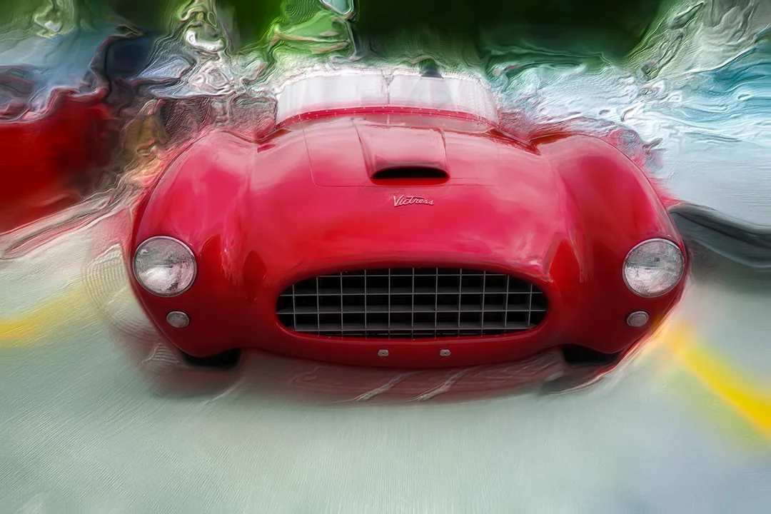 Digital painting of a red vintage Victress roadster head-on, with a mesh grille and hood scoop, backed by green ribboned foliage.