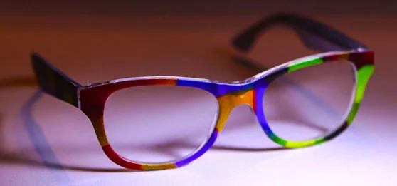 Eyewear product design concept: cat-eye eyeglass frames with diagonal red, blue, yellow and green banded iZoot artwork.